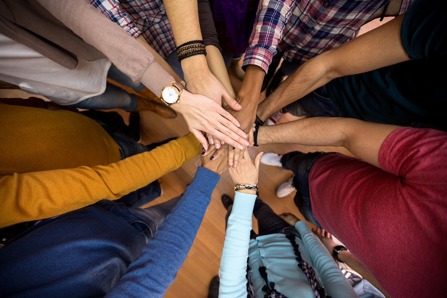 Hands of various ethnicities together in a circle
