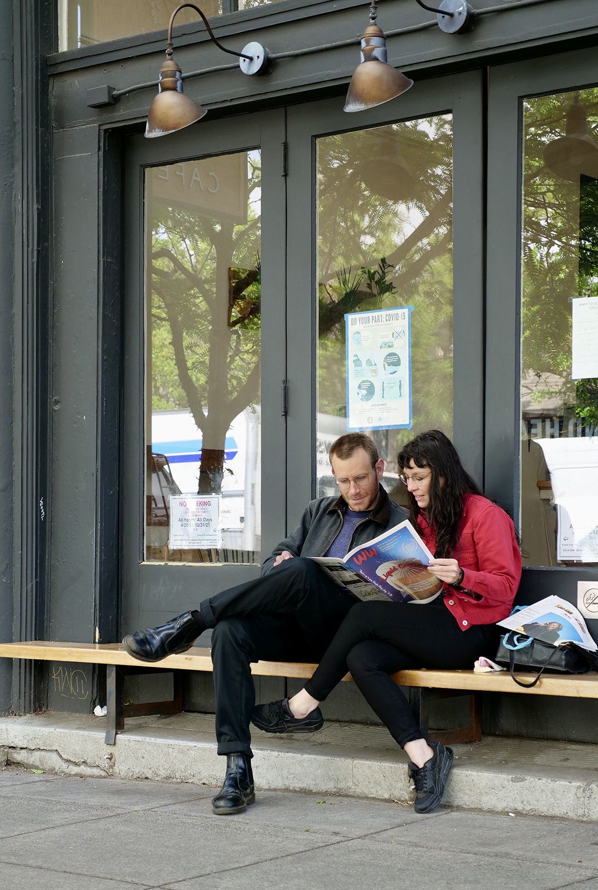 Male and female sitting together on a bench