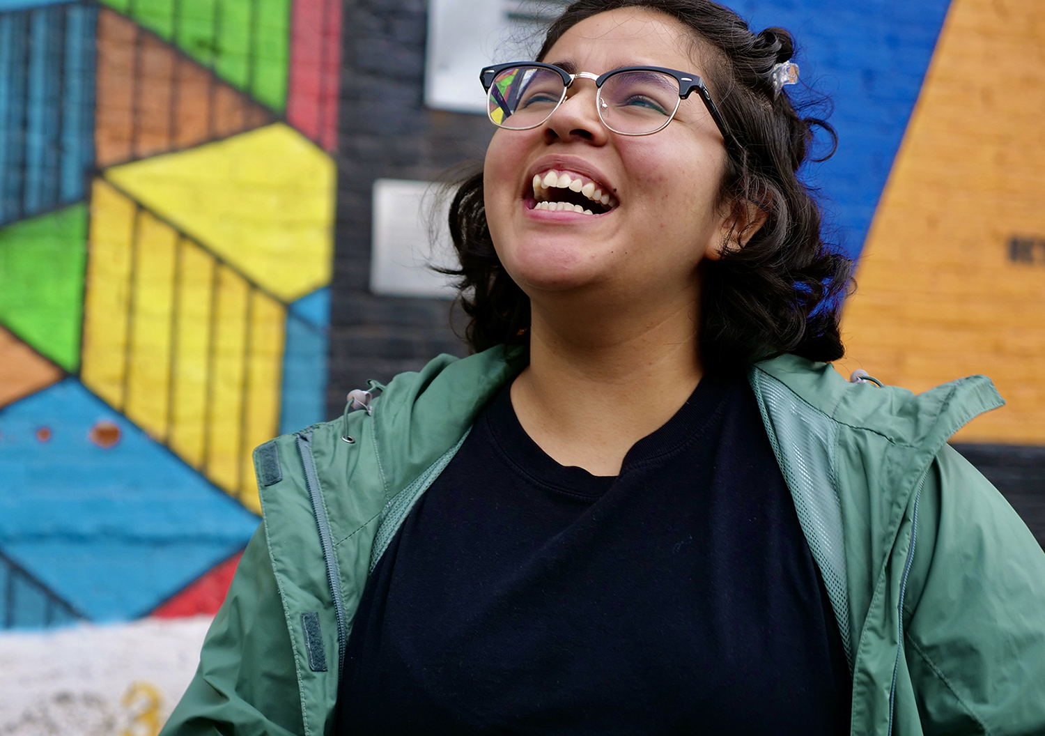 Elvia, bridge user, smiling in front of colored building