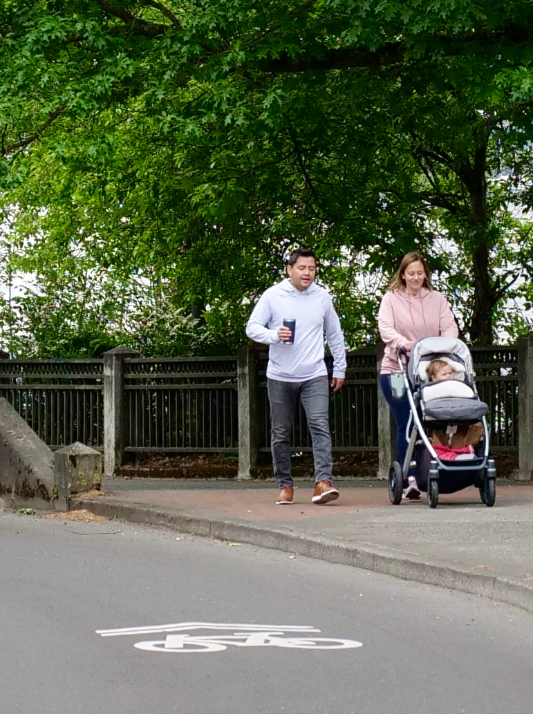 Couple walking under bridge. 