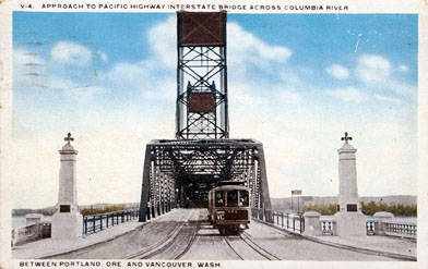 Historic photo of the Interstate Bridge showing a train crossing from when there used to be rail tracks across the bridge.