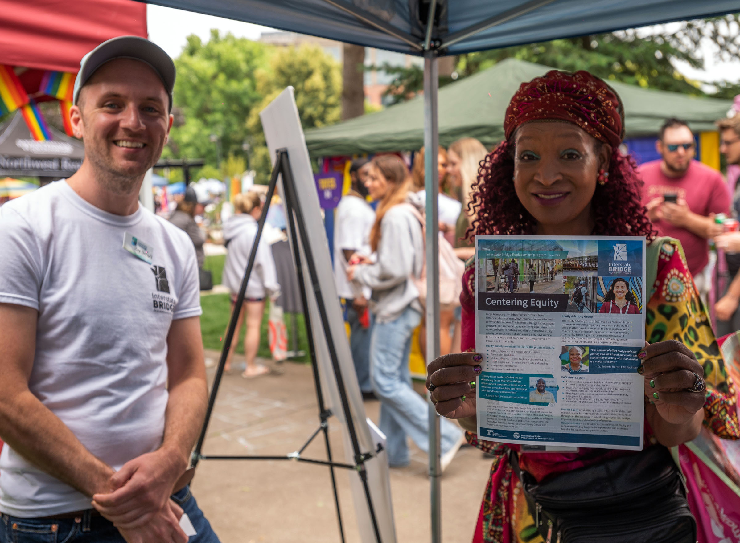 Image of community member holding an IBR factsheet focused on centering equity
